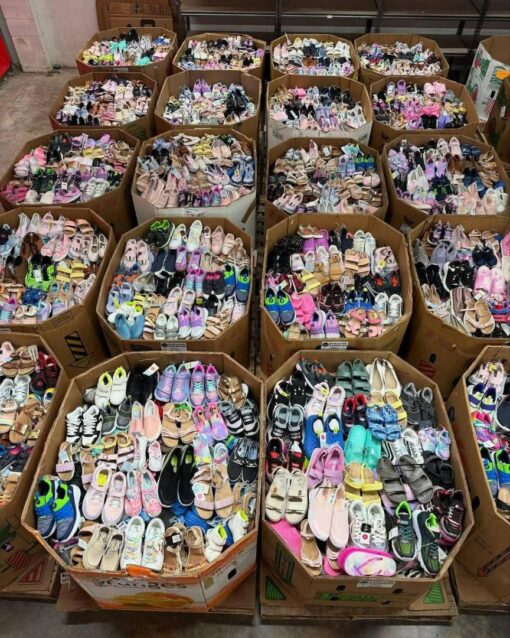 Pallet of assorted brand-new kids’ shoes in various styles, sizes, and colors – includes sneakers, boots, and sandals